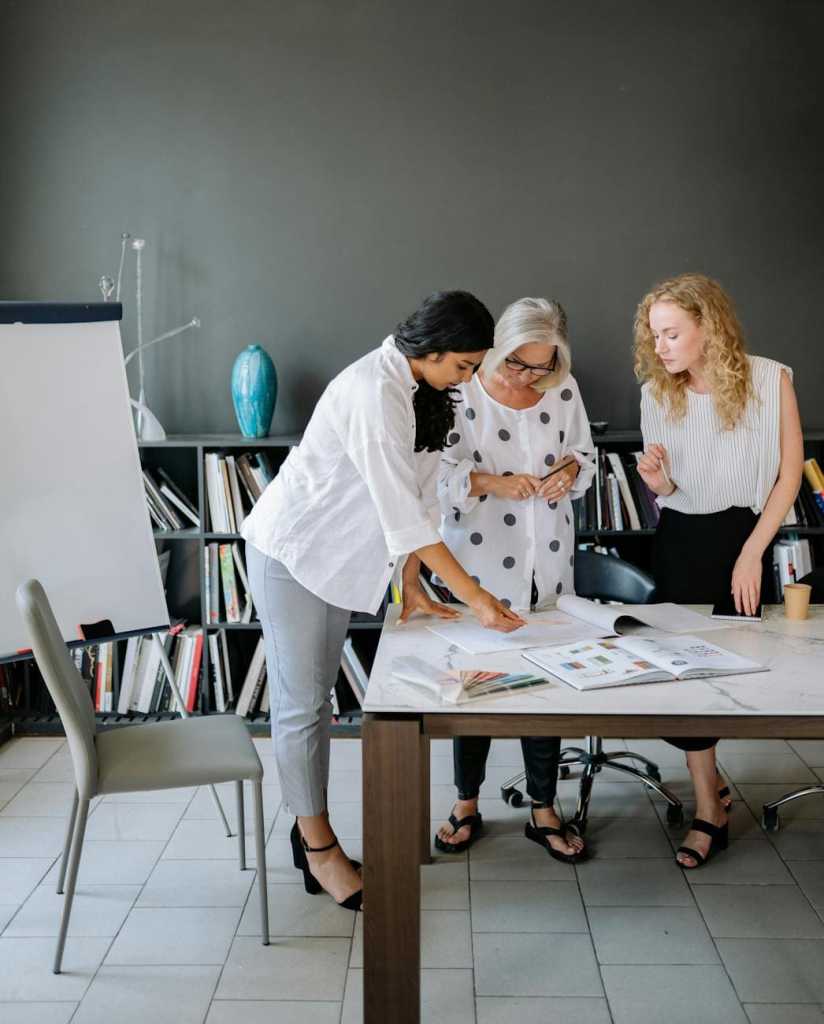 A confident B2B Fractional CMO leading a marketing team in a modern office setting.
